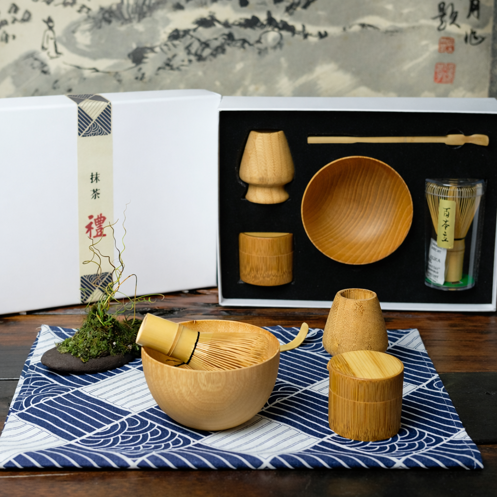 Set of wooden tea-making tools on a table with a traditional Japanese painting in the background.