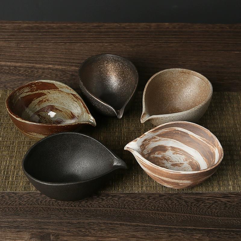 Set of five ceramic bowls with marbled patterns on a wooden surface.