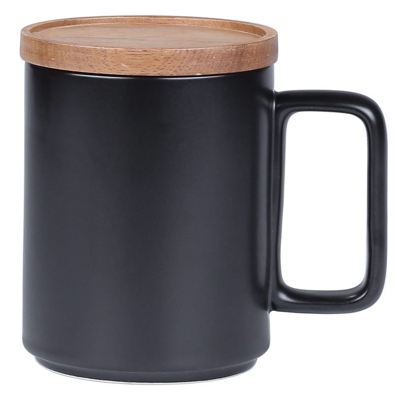 Black mug with a wooden lid on a white background
