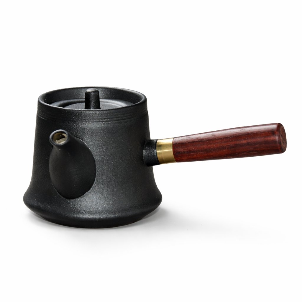 Black teapot with a wooden handle on a white background