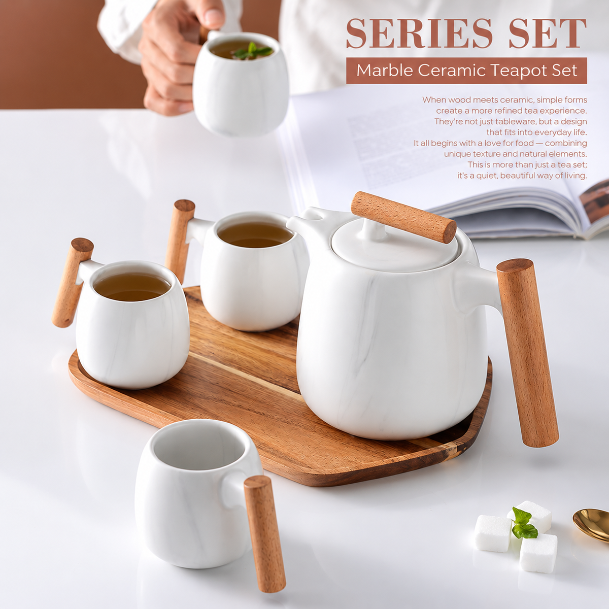 A marble ceramic teapot set with white glazed pots and cups and light brown wooden handles and tray, shown on a white tabletop with a hand holding one cup. The image includes promotional text reading 'SERIES SET Marble Ceramic Teapot Set'.