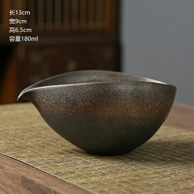 Black ceramic teapot on a textured surface with dimensions displayed
