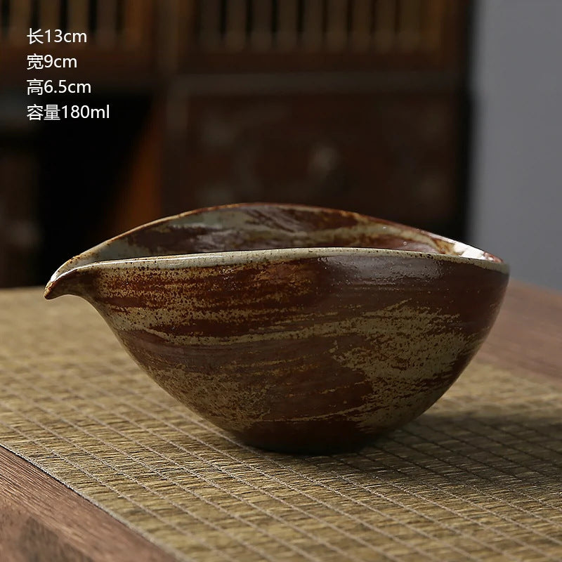 Ceramic teapot on a textured surface with dimensions displayed