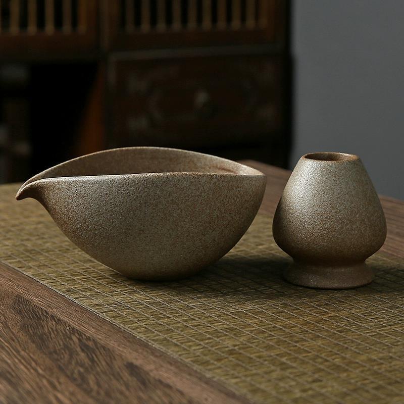 Two ceramic bowls on a textured surface with a blurred background