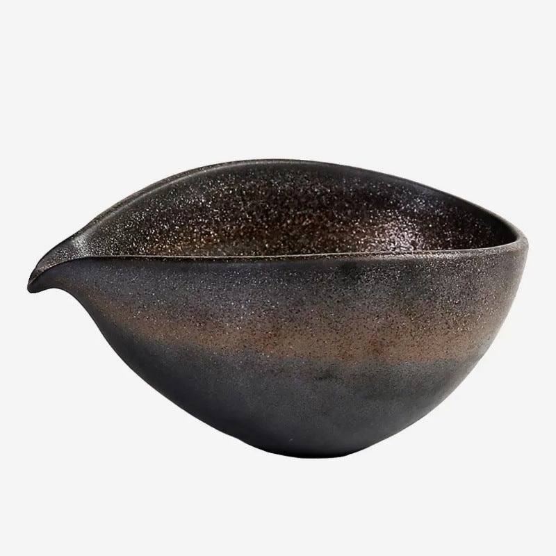Black ceramic bowl with speckled texture on a white background