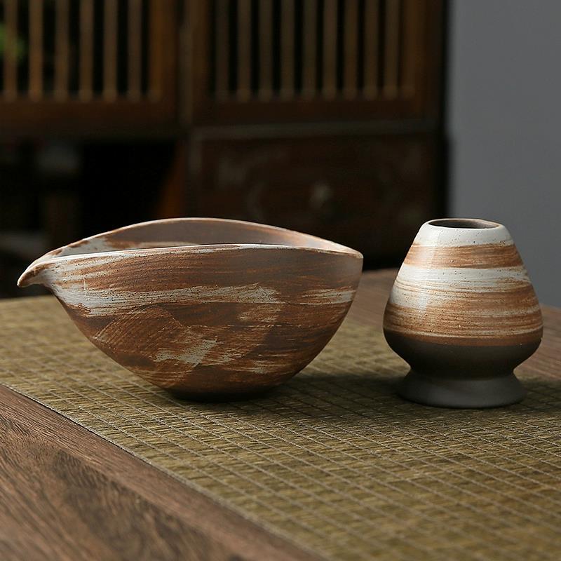 Two ceramic bowls on a textured surface with a blurred background