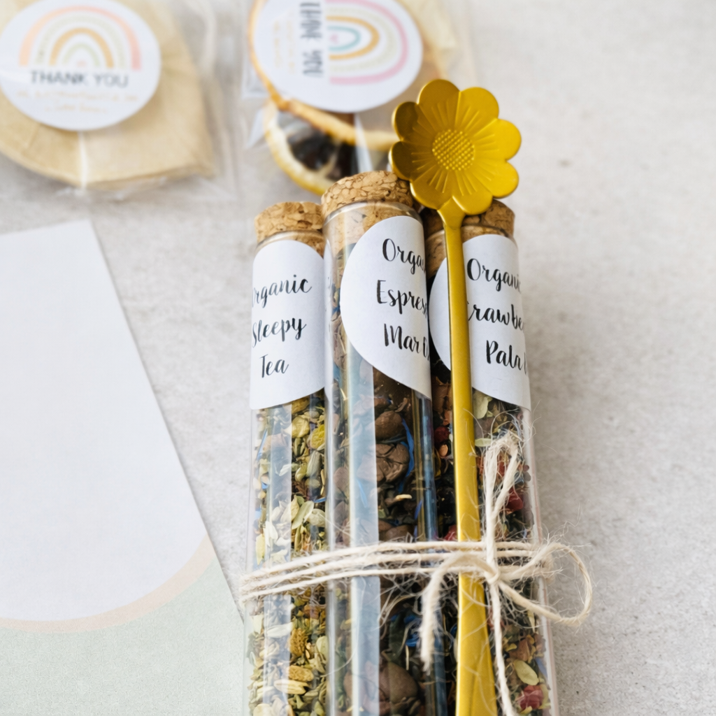 Three glass tubes filled with tea leaves, each labeled with a white tag, on a light background.